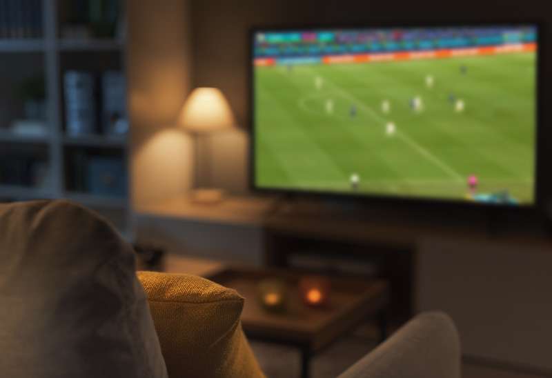 TV with football game in the background for Super Bowl blog