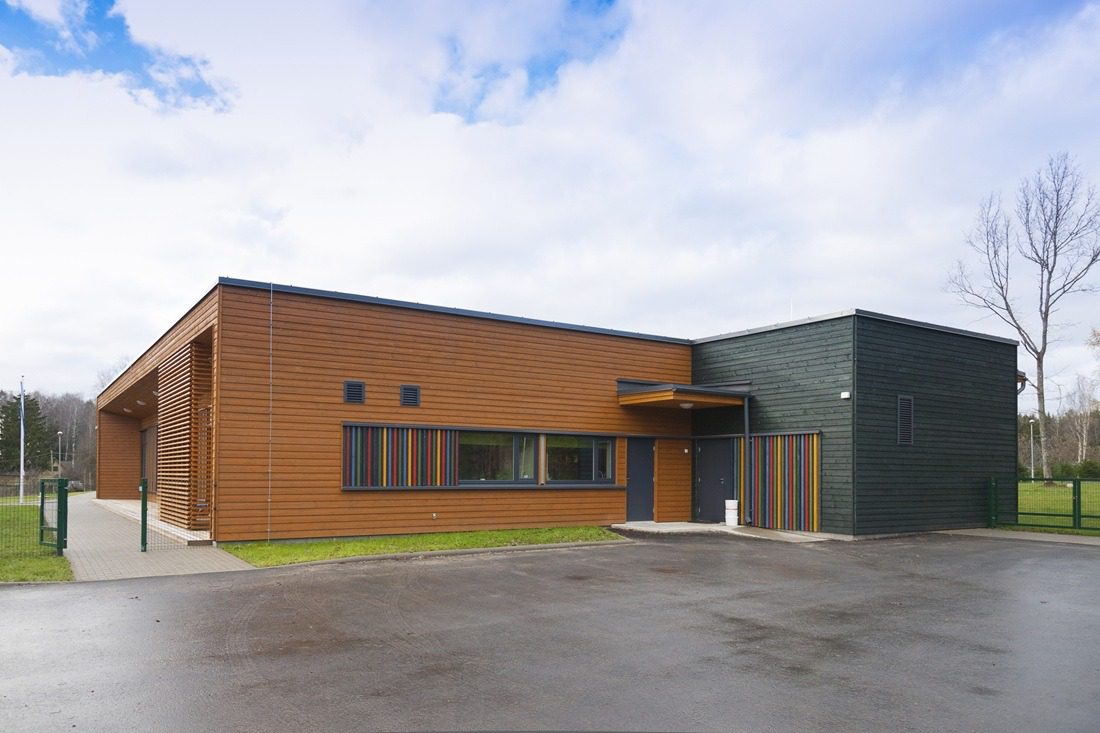 A modern building, a pre-school entrance and playground