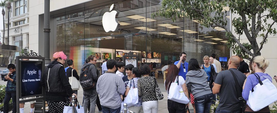 Showing an example of brand loyalty this photo shows a long line of customers waiting for the news product from Apple.