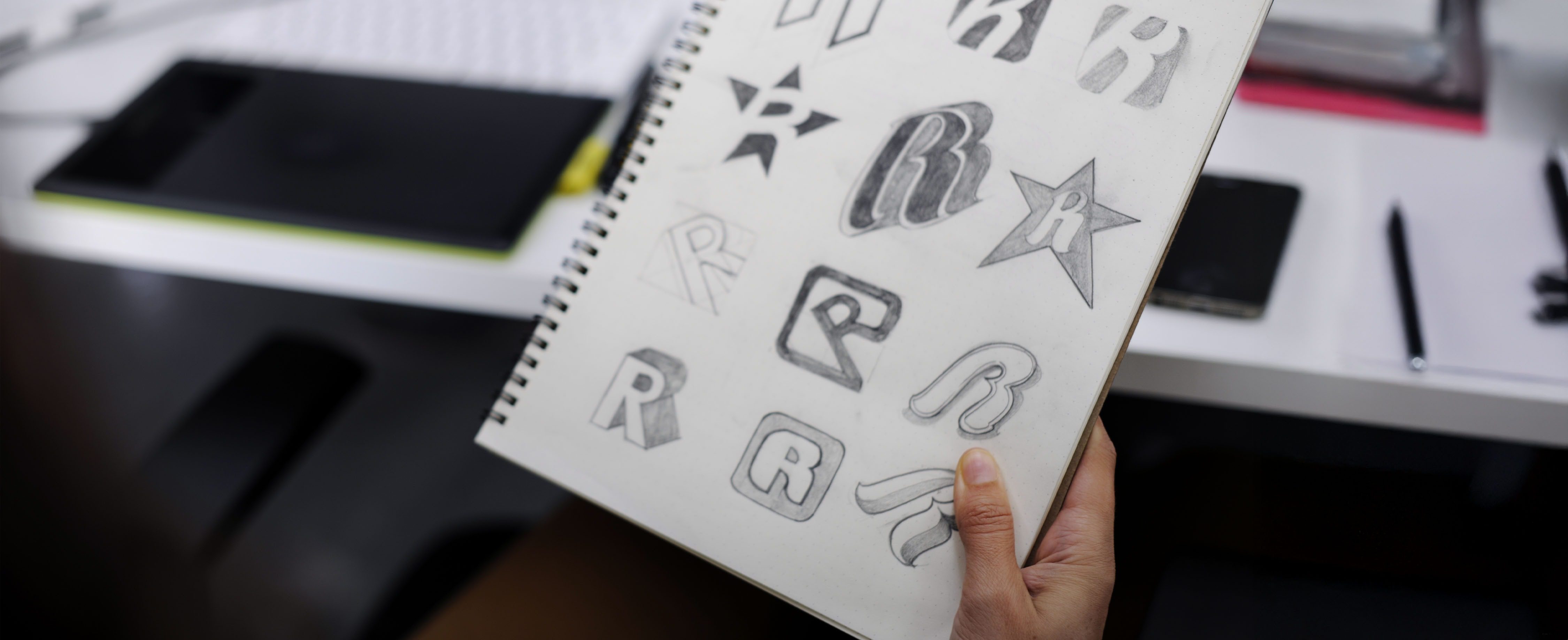 Hand Holding Notebook With Drew Brand Logo Creative for digital marketing faqs